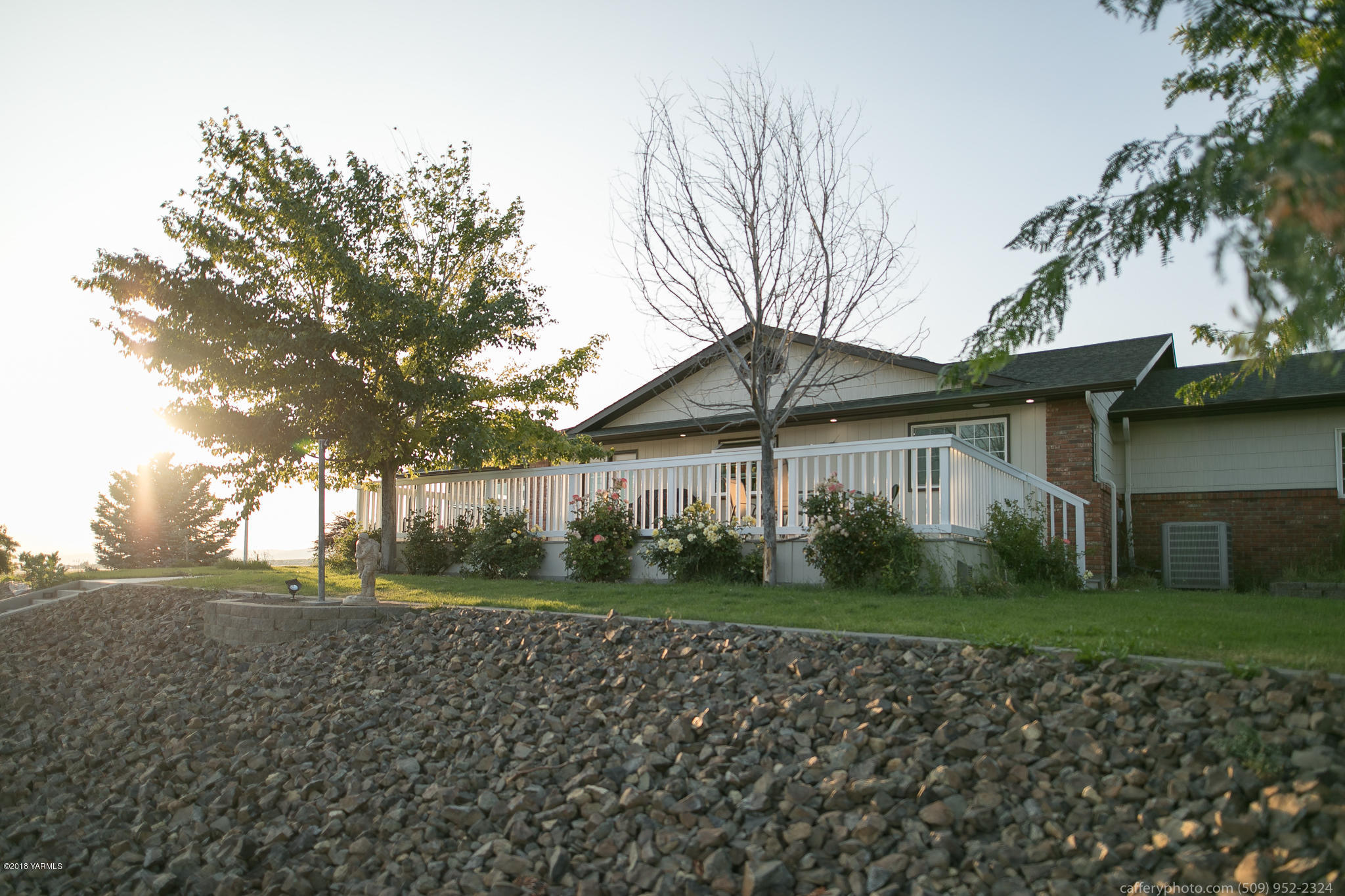 11517 Mieras Road Yakima, WA 98901 - Photo 19 of 57 a front view of a house with a yard and potted plants