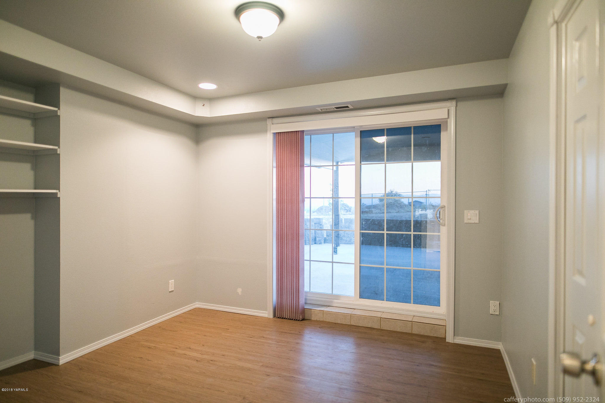11517 Mieras Road Yakima, WA 98901 - Photo 24 of 57 an empty room with wooden floor and windows