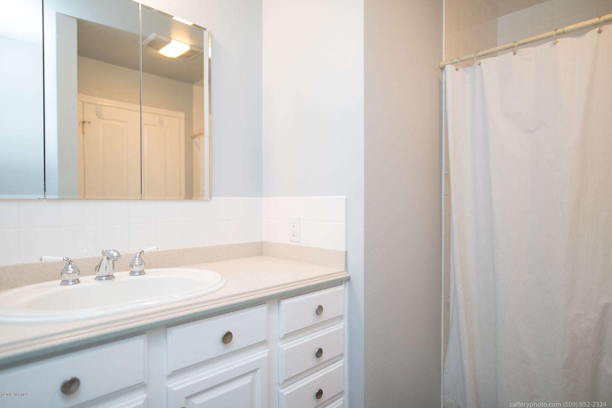 11517 Mieras Road Yakima, WA 98901 - Photo 31 of 57 a bathroom with a sink and a mirror