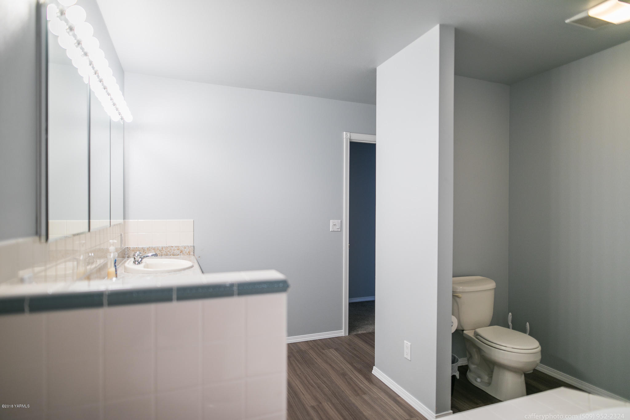 11517 Mieras Road Yakima, WA 98901 - Photo 39 of 57 a bathroom with a sink toilet and vanity