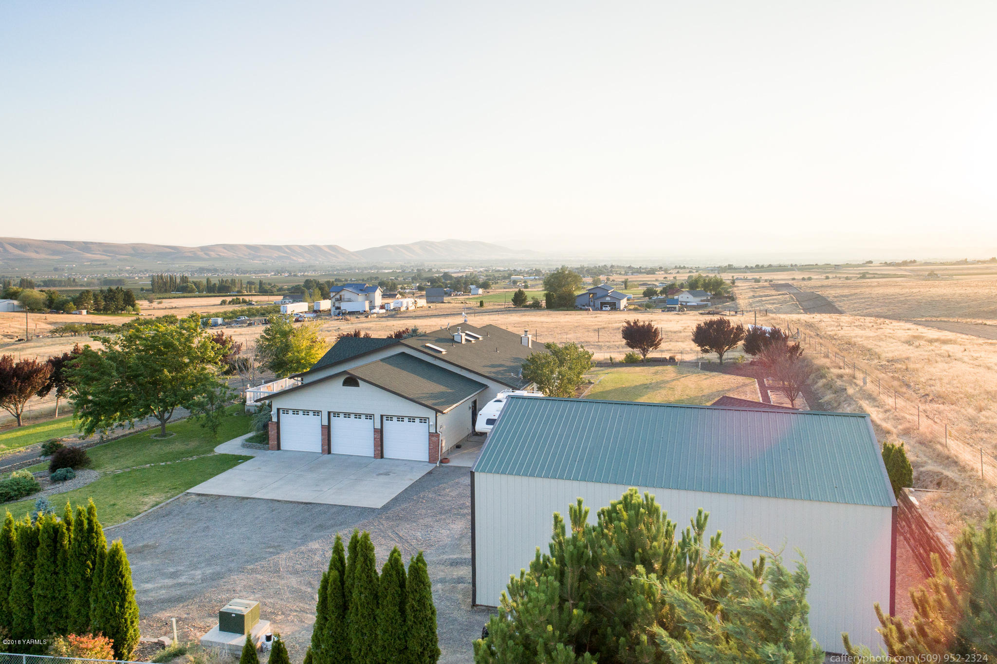 11517 Mieras Road Yakima, WA 98901 - Photo 5 of 57 an aerial view of a house with a garden and lake view