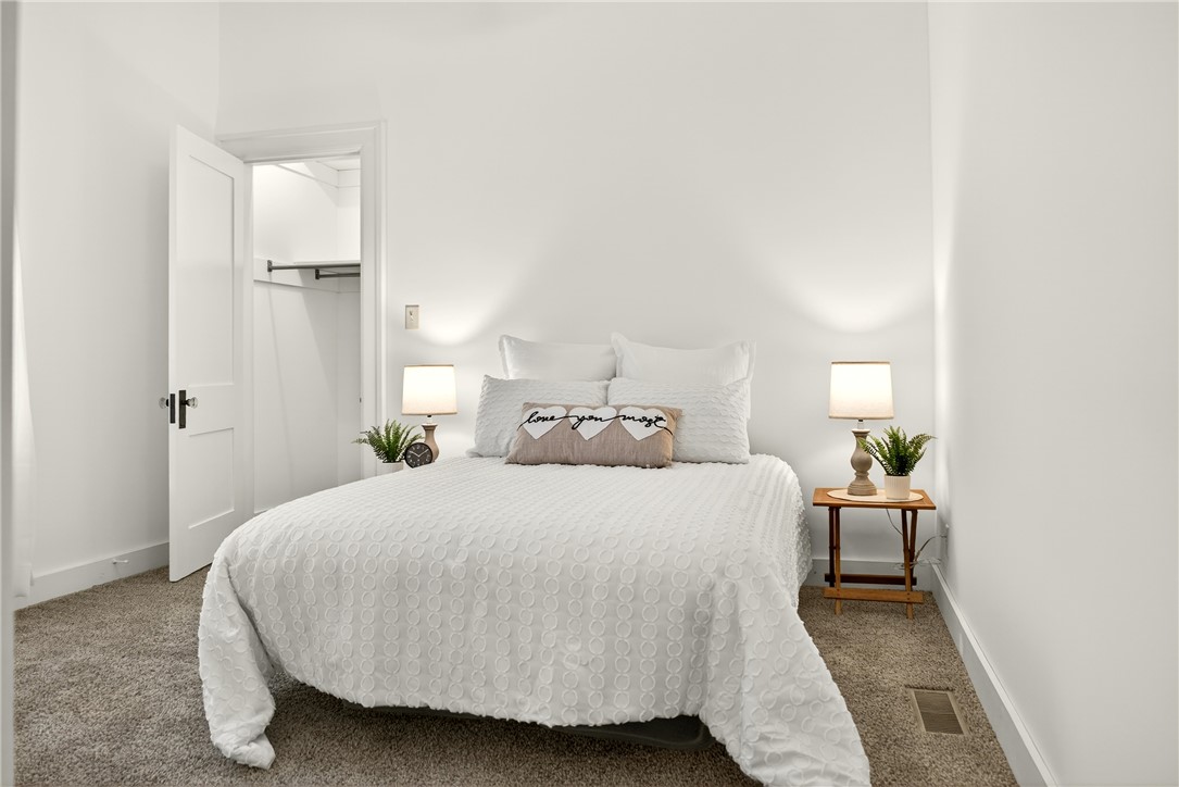 107 Riverside Drive Piqua, OH 45356 - Photo 24 of 69 This cozy bedroom features plush carpeting and a convenient walk-in closet.