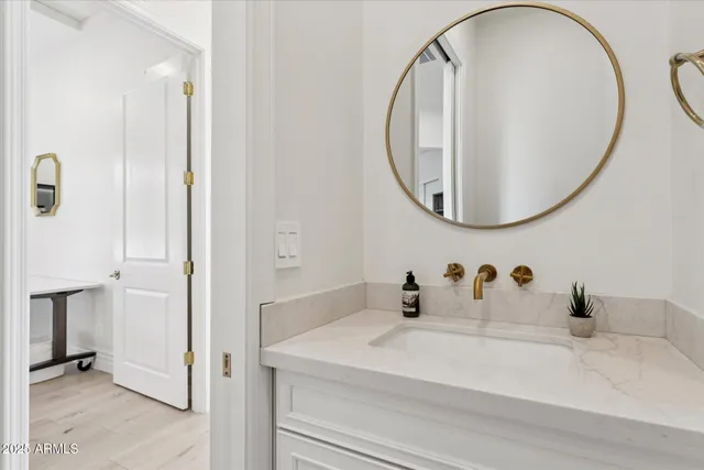 a bathroom with a sink and mirror