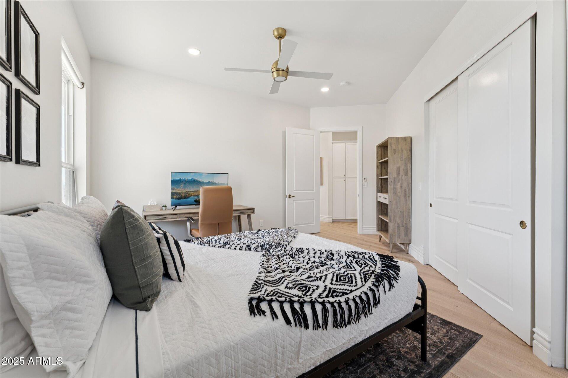 221 West Jomax Road, Unit 1 Phoenix, AZ 85085 - Photo 20 of 26 a bedroom with a large bed and a chandelier