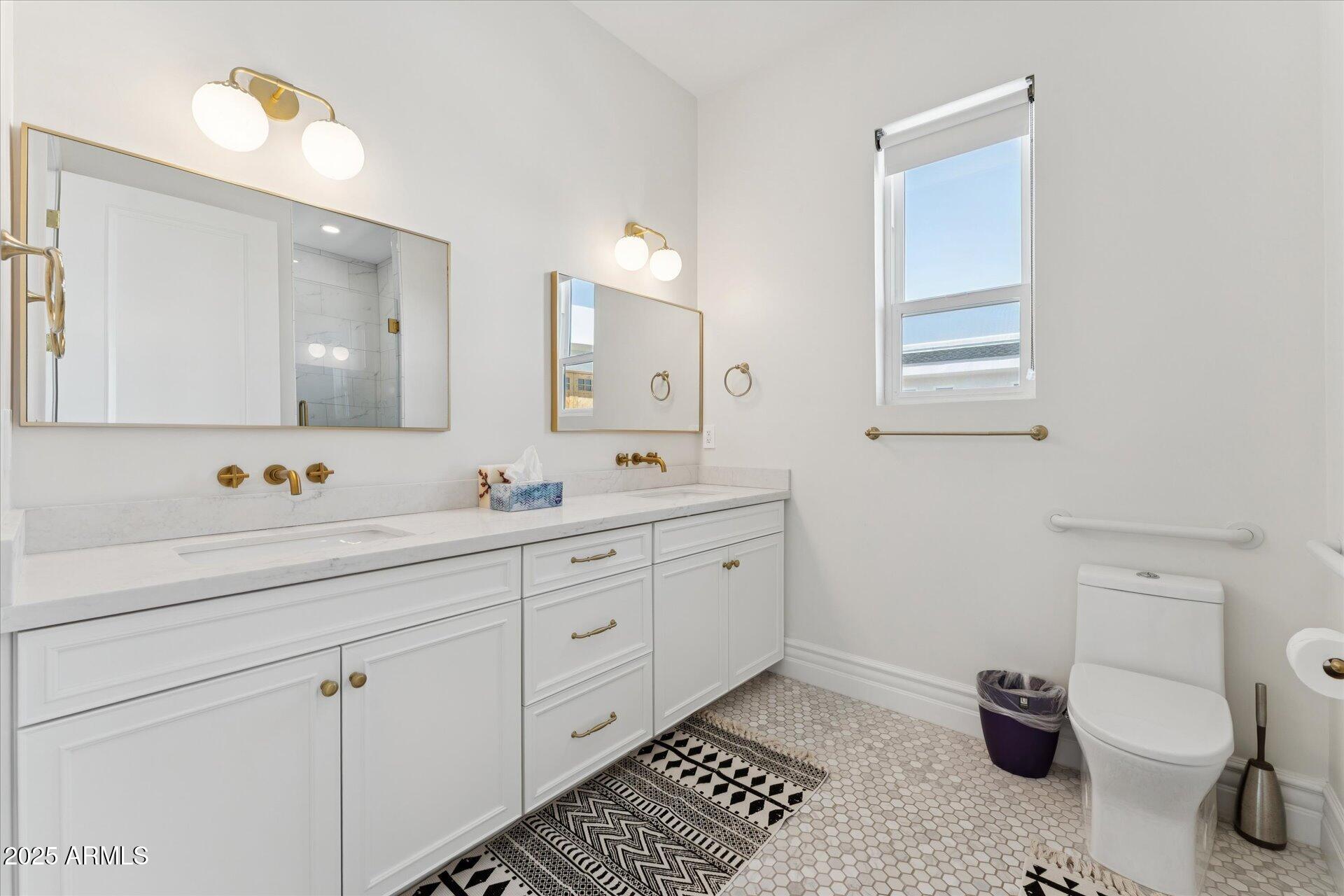 221 West Jomax Road, Unit 1 Phoenix, AZ 85085 - Photo 22 of 26 a bathroom with a double vanity sink and a toilet