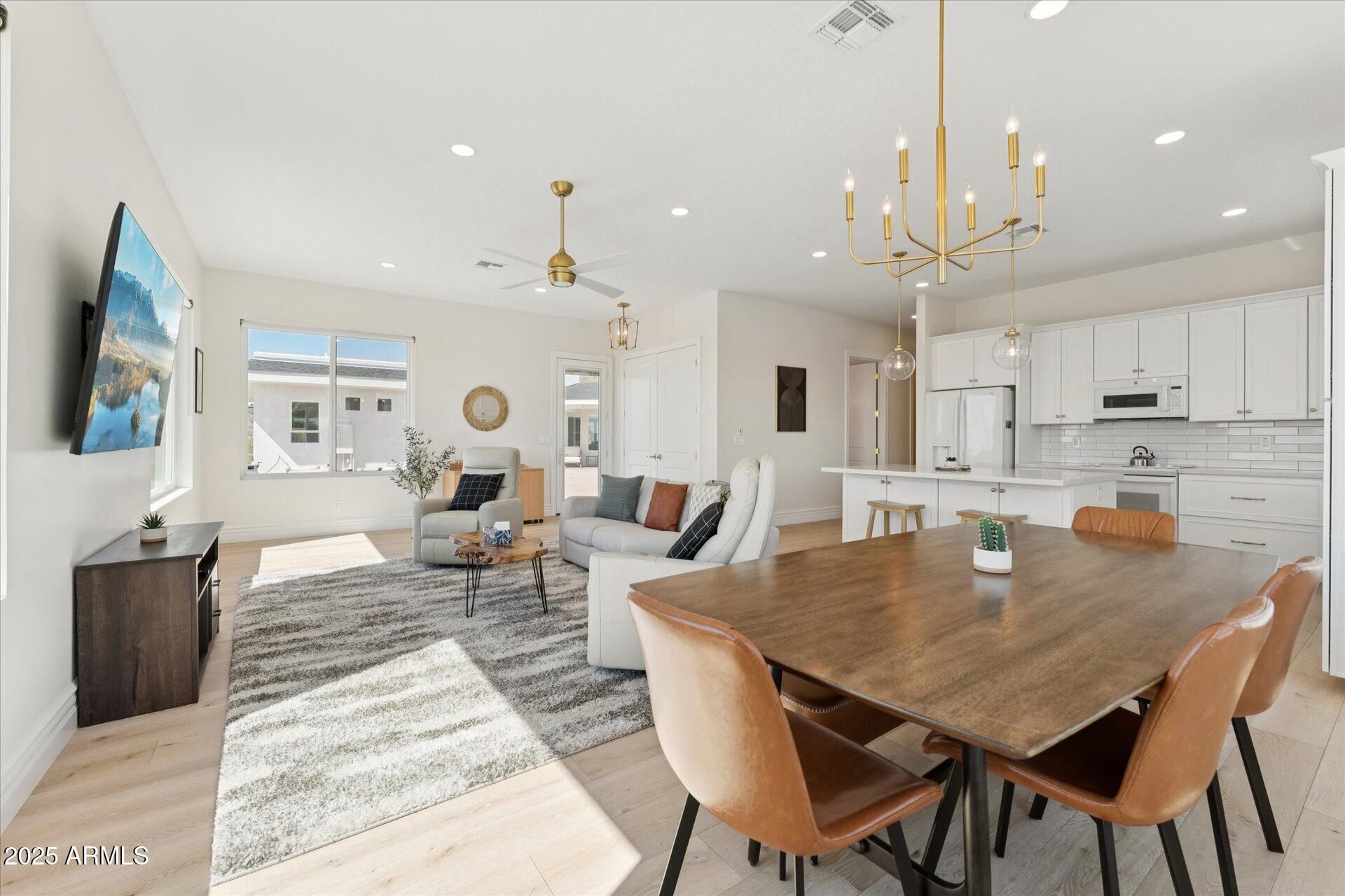 221 West Jomax Road, Unit 1 Phoenix, AZ 85085 - Photo 3 of 26 a large kitchen with a table and chairs