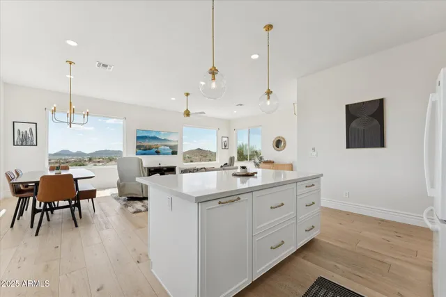 a kitchen with a sink cabinets and wooden floor