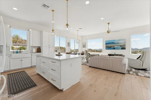 a large white kitchen with cabinets