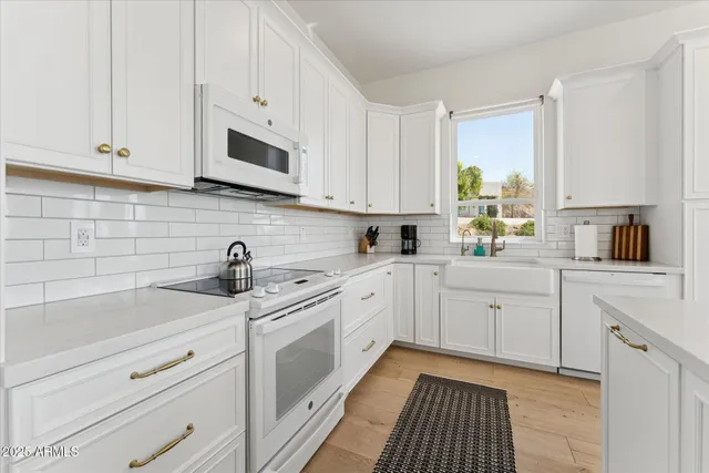 a kitchen with appliances cabinets and a sink