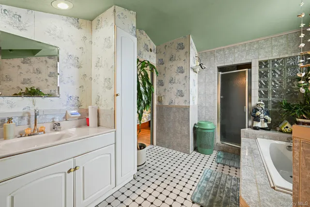 a bathroom with a sink a mirror and shower