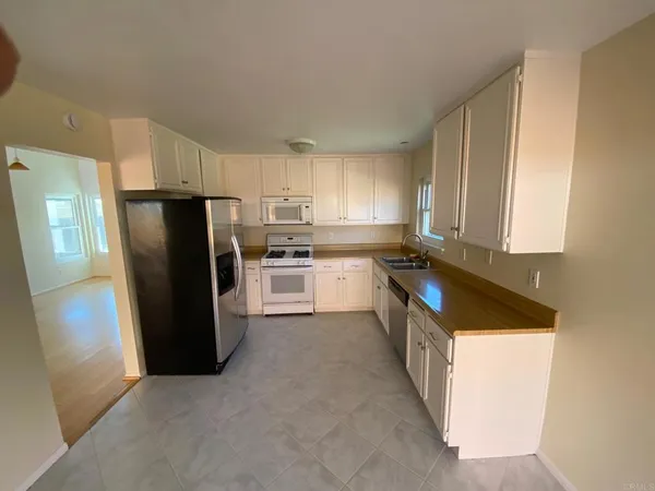 a kitchen with a refrigerator a stove a sink and a window