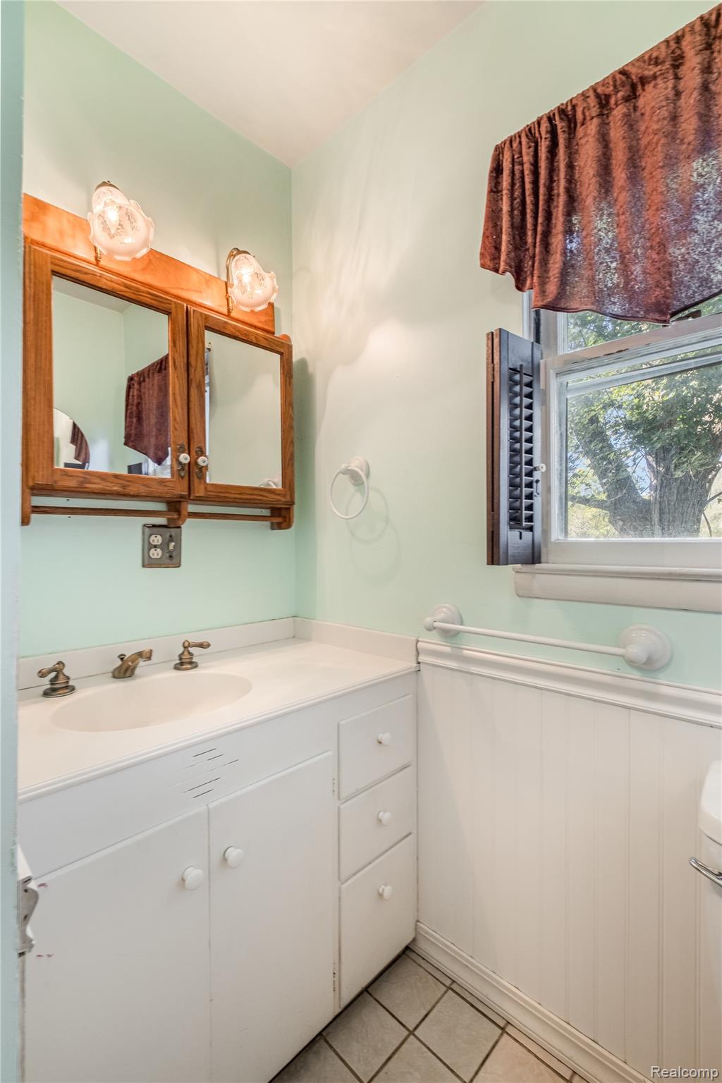 5447 North State Road Davison, MI 48423 - Photo 13 of 29 Half bath with vanity and light tile patterned floors