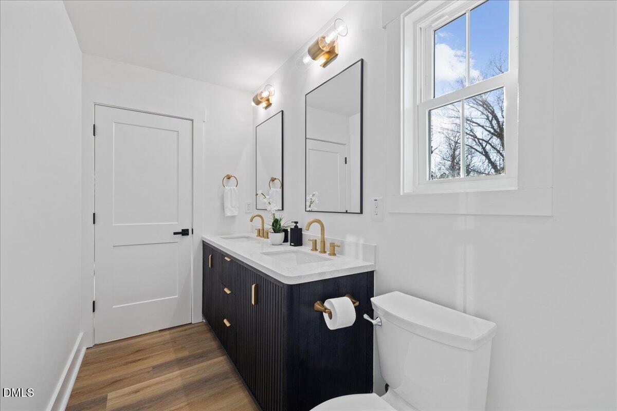 617 North 3rd Street Mebane, NC 27302 - Photo 32 of 50 a bathroom with a sink vanity and a mirror