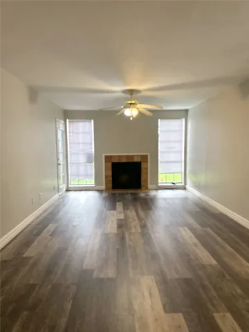 an empty room with a fireplace and window