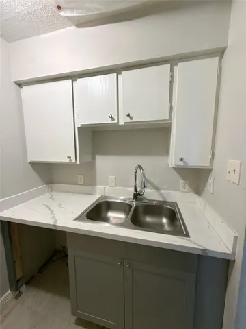 a kitchen with a sink a cabinets and window