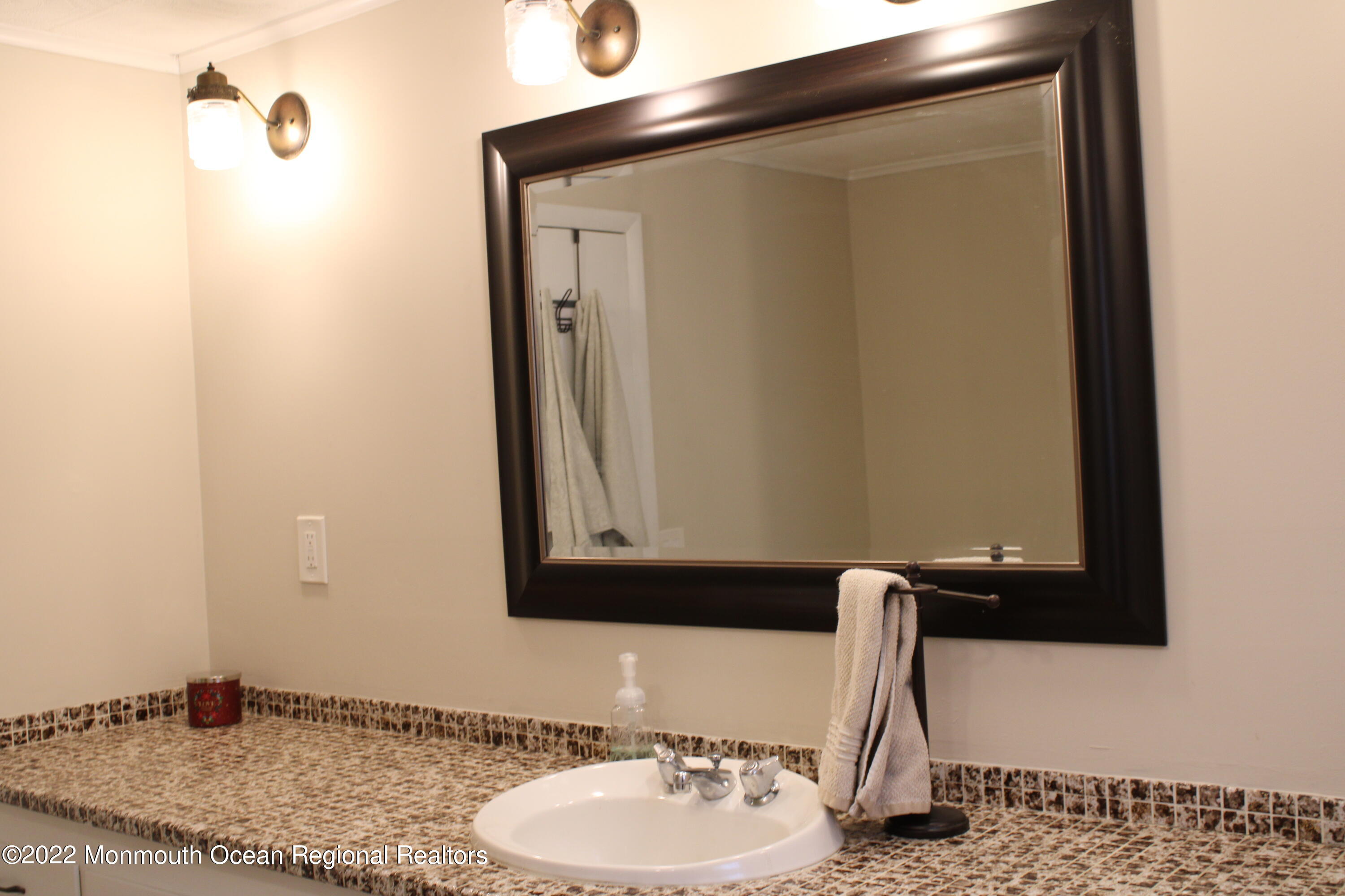 2001 Diana Road Wall, NJ 07719 - Photo 19 of 39 a bathroom with a granite countertop sink and a mirror