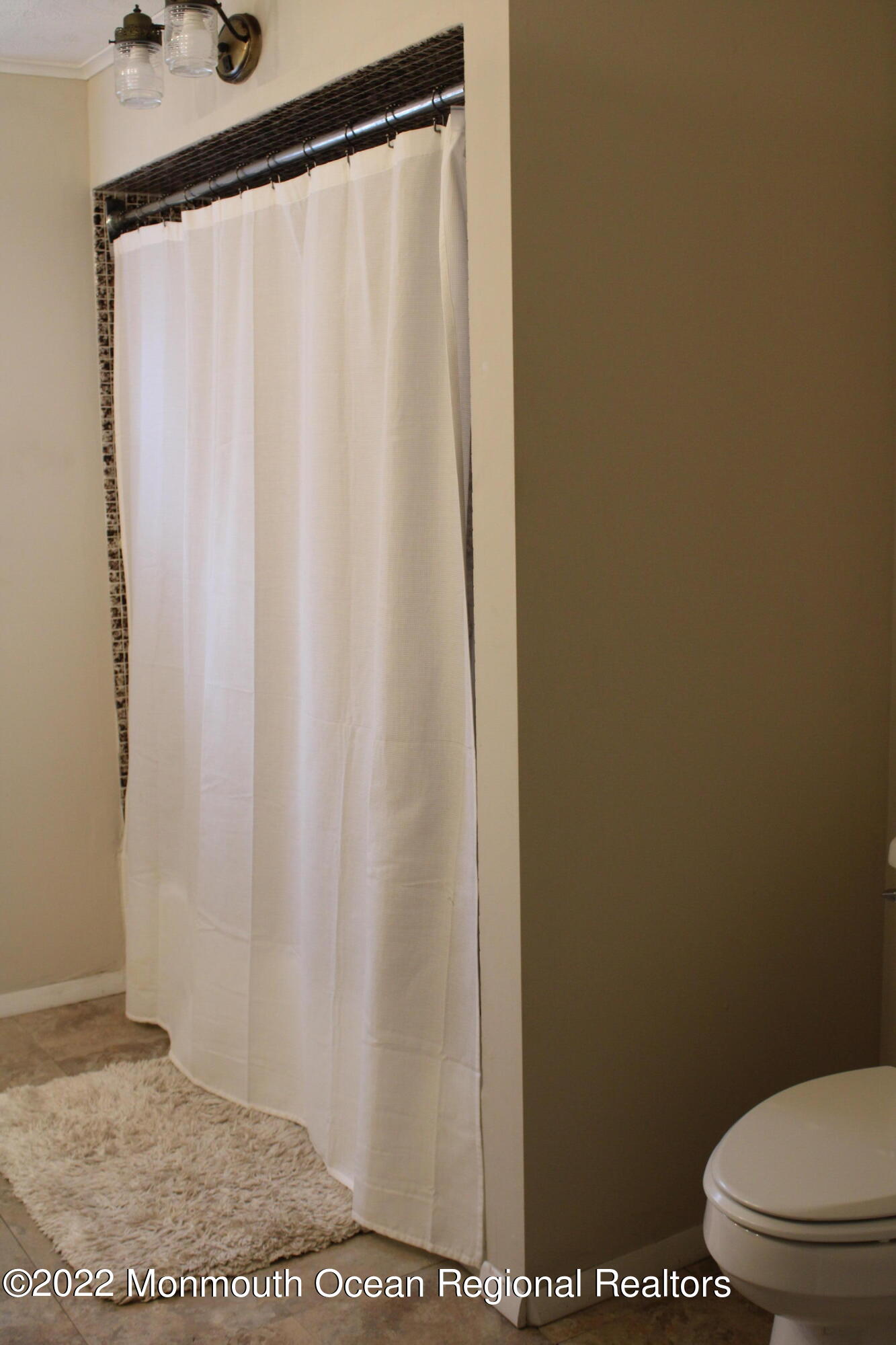 2001 Diana Road Wall, NJ 07719 - Photo 20 of 39 a bathroom with a shower curtain and sink
