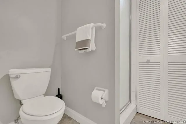 a white toilet sitting next to a bathroom sink