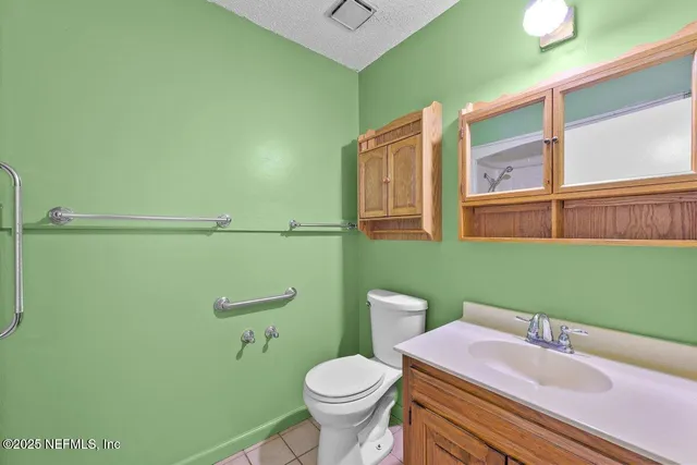 a bathroom with a sink a toilet and mirror