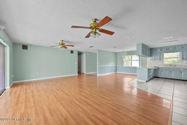 a view of a livingroom with a ceiling fan and window