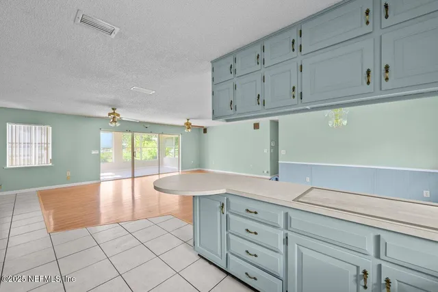 a spacious bathroom with a sink and a mirror