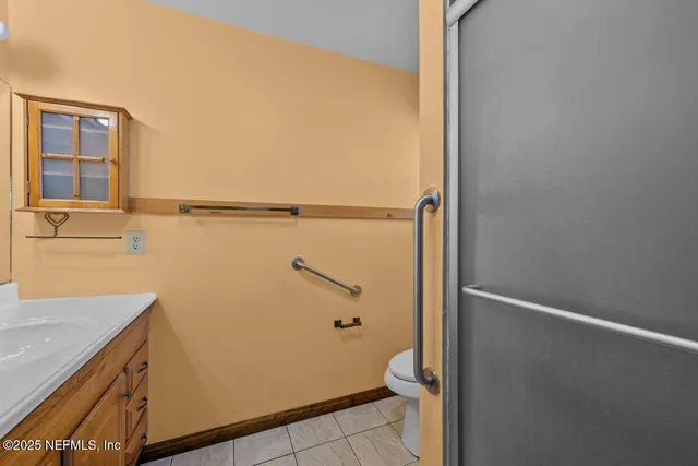 a bathroom with a granite countertop shower and a sink
