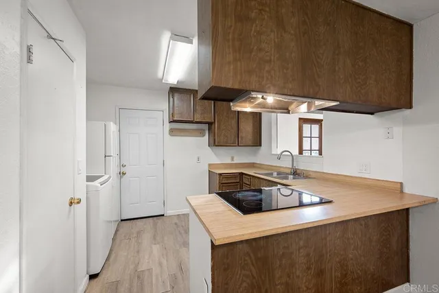 a kitchen with a sink a stove and a refrigerator