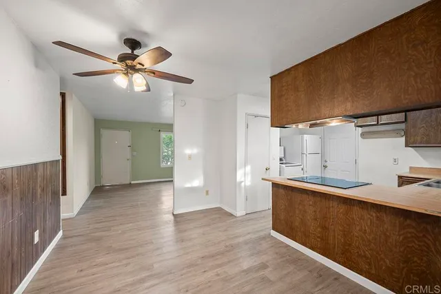 a view of a kitchen with a sink and wooden floor