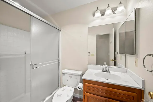 a bathroom with a sink toilet and a mirror
