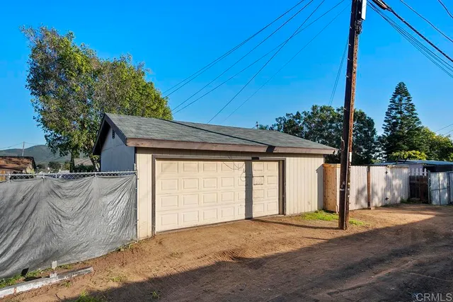 a view of a house with a backyard and garage