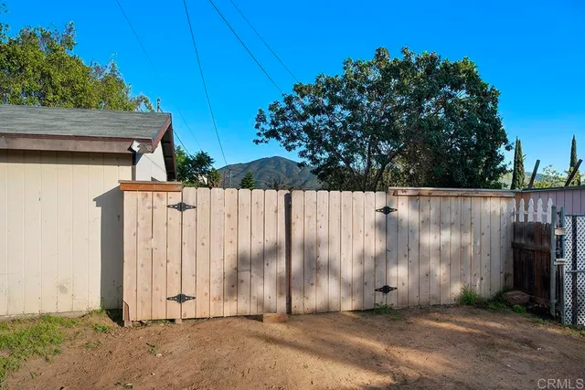 a view of outdoor space with wooden fence