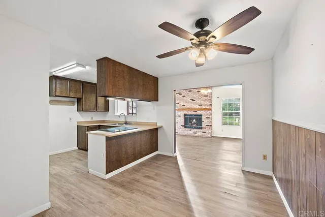 a view of kitchen with sink microwave and stove