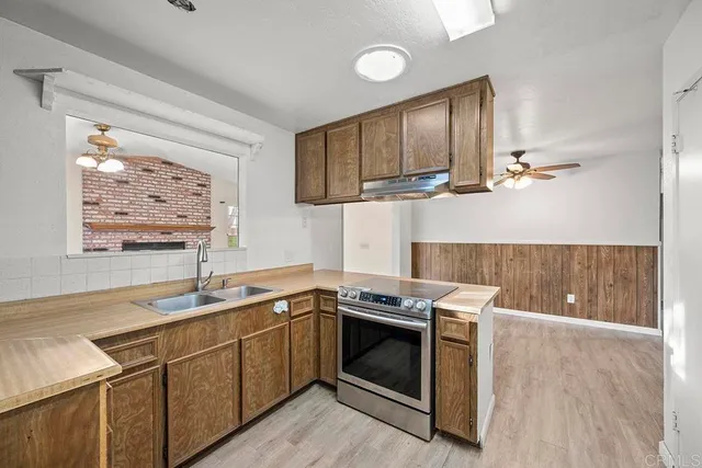 a kitchen with a stove microwave and sink