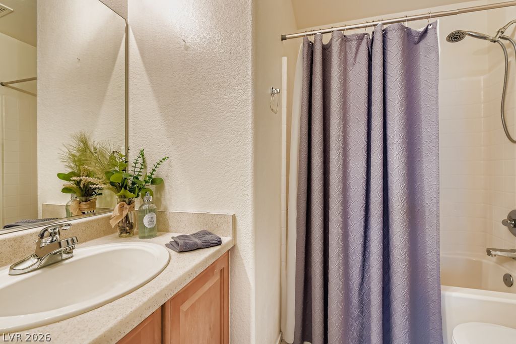 1586 Rusty Ridge Lane Henderson, NV 89002 - Photo 6 of 11 Functional vanity with ample counter space paired with a pristine shower-tub combination.