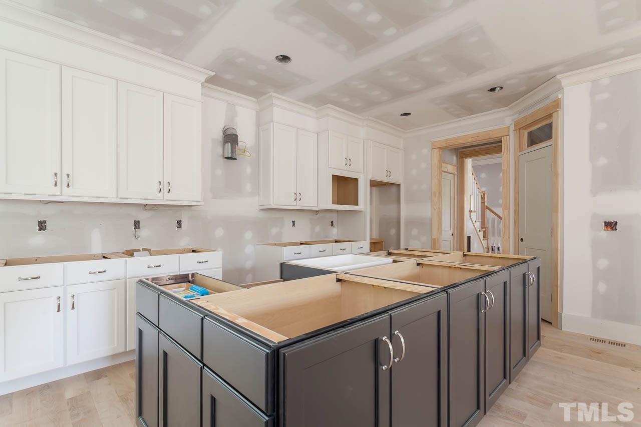 309 Georgetown Road Raleigh, NC 27608 - Photo 3 of 19 a kitchen with a sink stove and cabinets