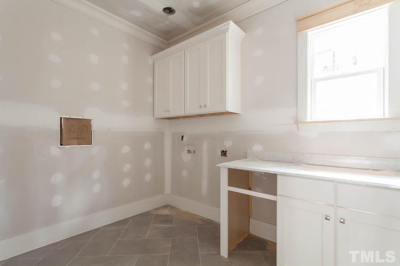 309 Georgetown Road Raleigh, NC 27608 - Photo 6 of 19 a room with a window and a table