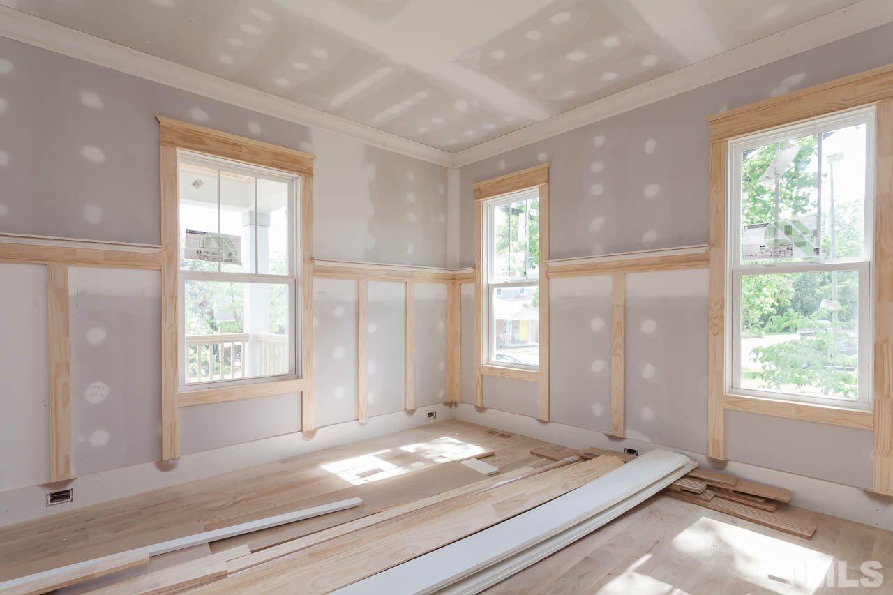 309 Georgetown Road Raleigh, NC 27608 - Photo 8 of 19 a view of a bedroom with wooden floor and windows