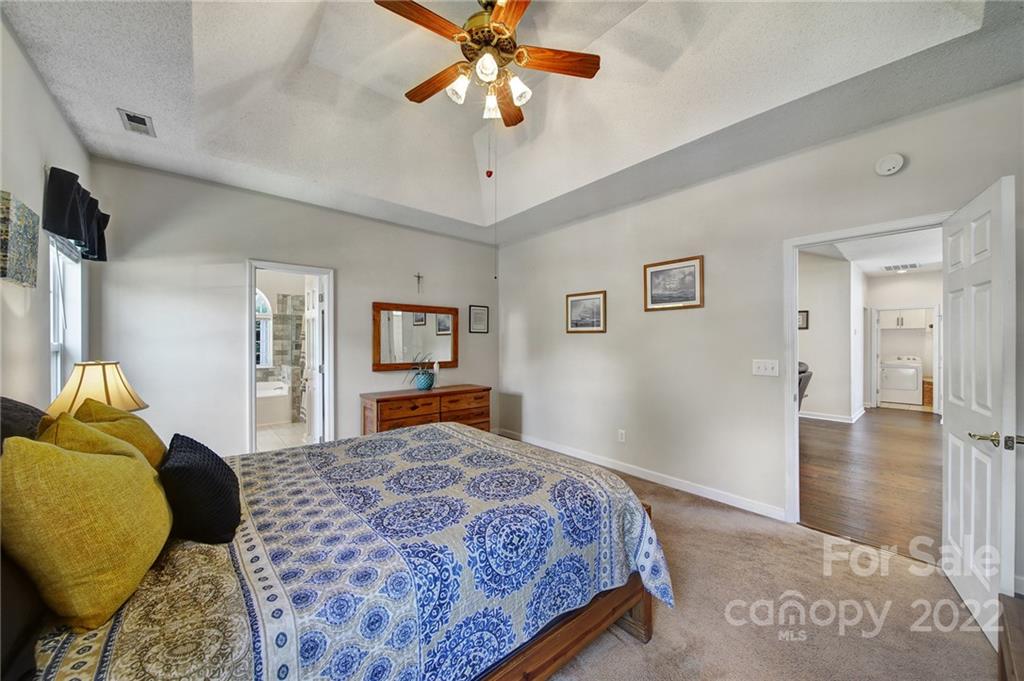 549 South Portman Lane Fort Mill, SC 29708 - Photo 20 of 39 a bedroom with a bed and a chandelier