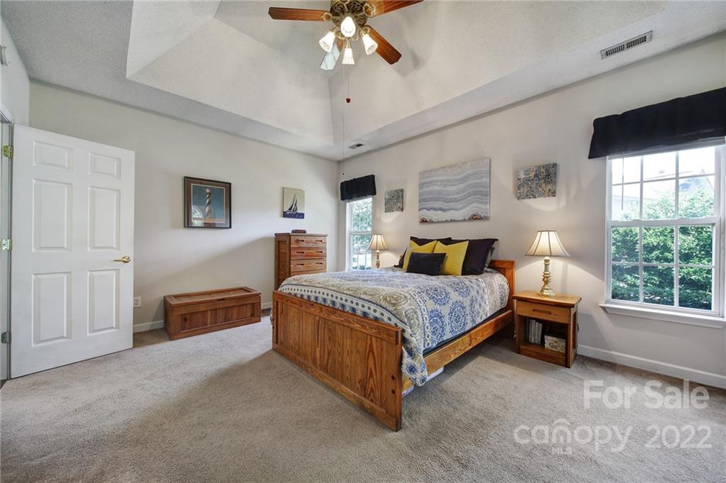 549 South Portman Lane Fort Mill, SC 29708 - Photo 21 of 39 a bedroom with a large bed and a chandelier fan