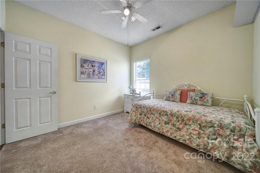 549 South Portman Lane Fort Mill, SC 29708 - Photo 29 of 39 a bedroom with a bed and a chandelier