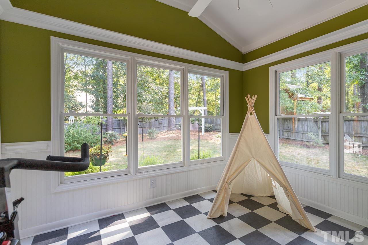 6103 Chesden Drive Durham, NC 27713 - Photo 11 of 22 a living room with a floor to ceiling window and a flat screen tv