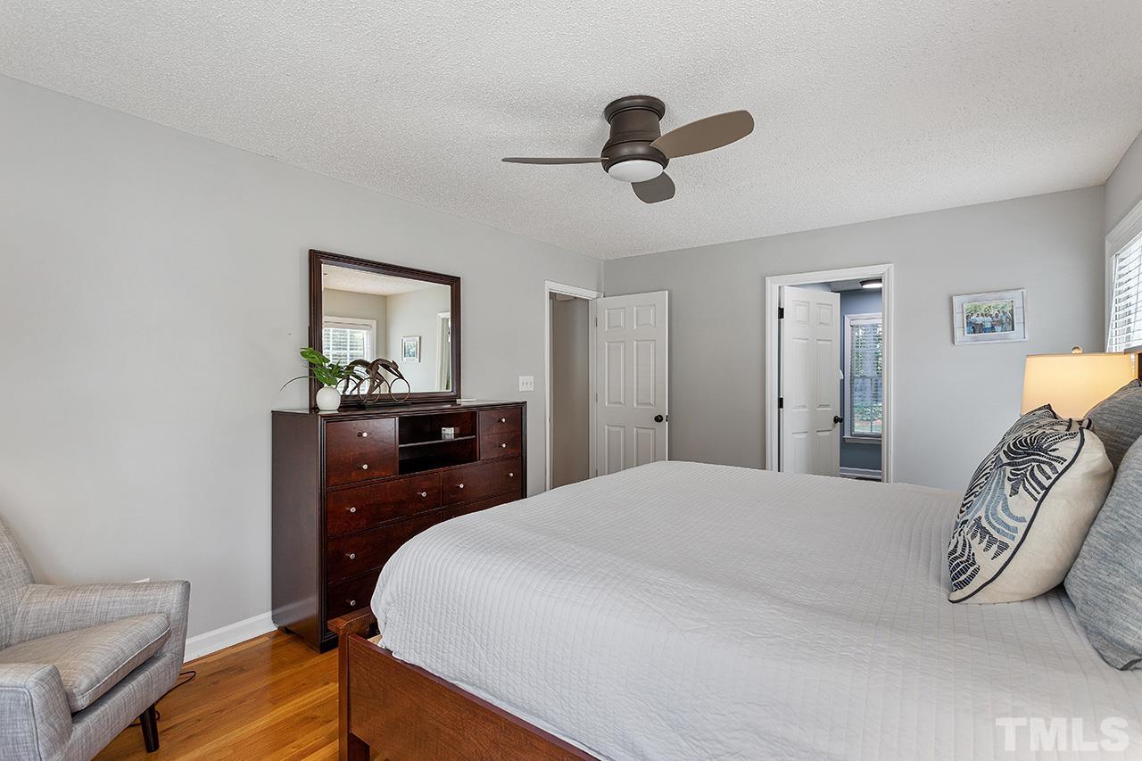 6103 Chesden Drive Durham, NC 27713 - Photo 13 of 22 a bedroom with a bed and a chandelier