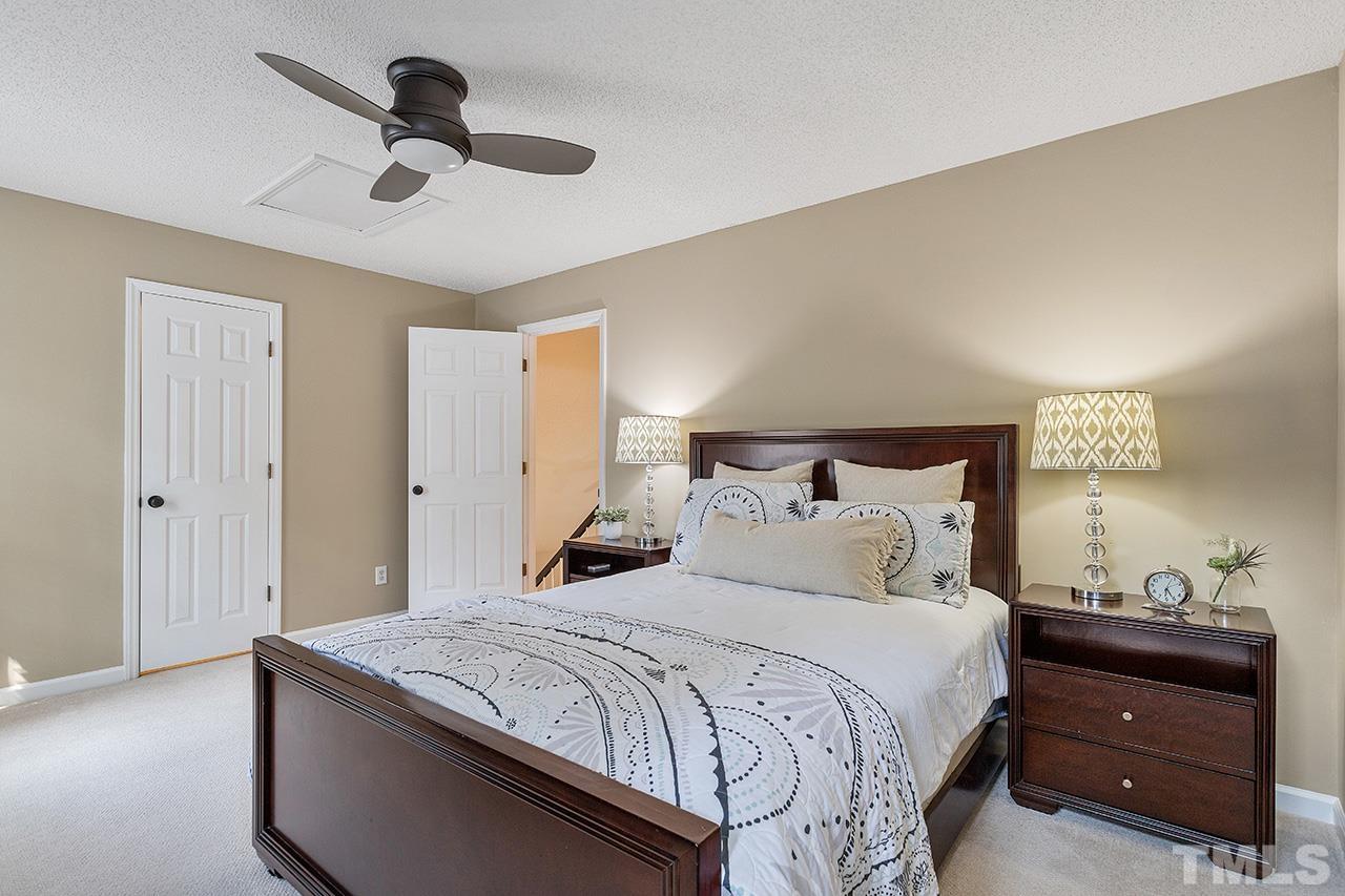 6103 Chesden Drive Durham, NC 27713 - Photo 15 of 22 a bedroom with a bed and a lamp on the dresser