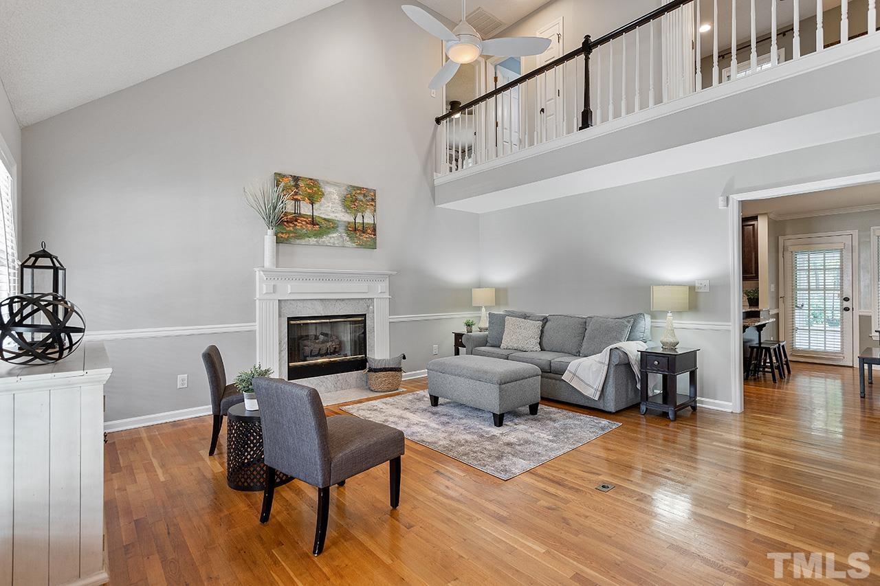 6103 Chesden Drive Durham, NC 27713 - Photo 4 of 22 a living room with furniture a fireplace and wooden floor