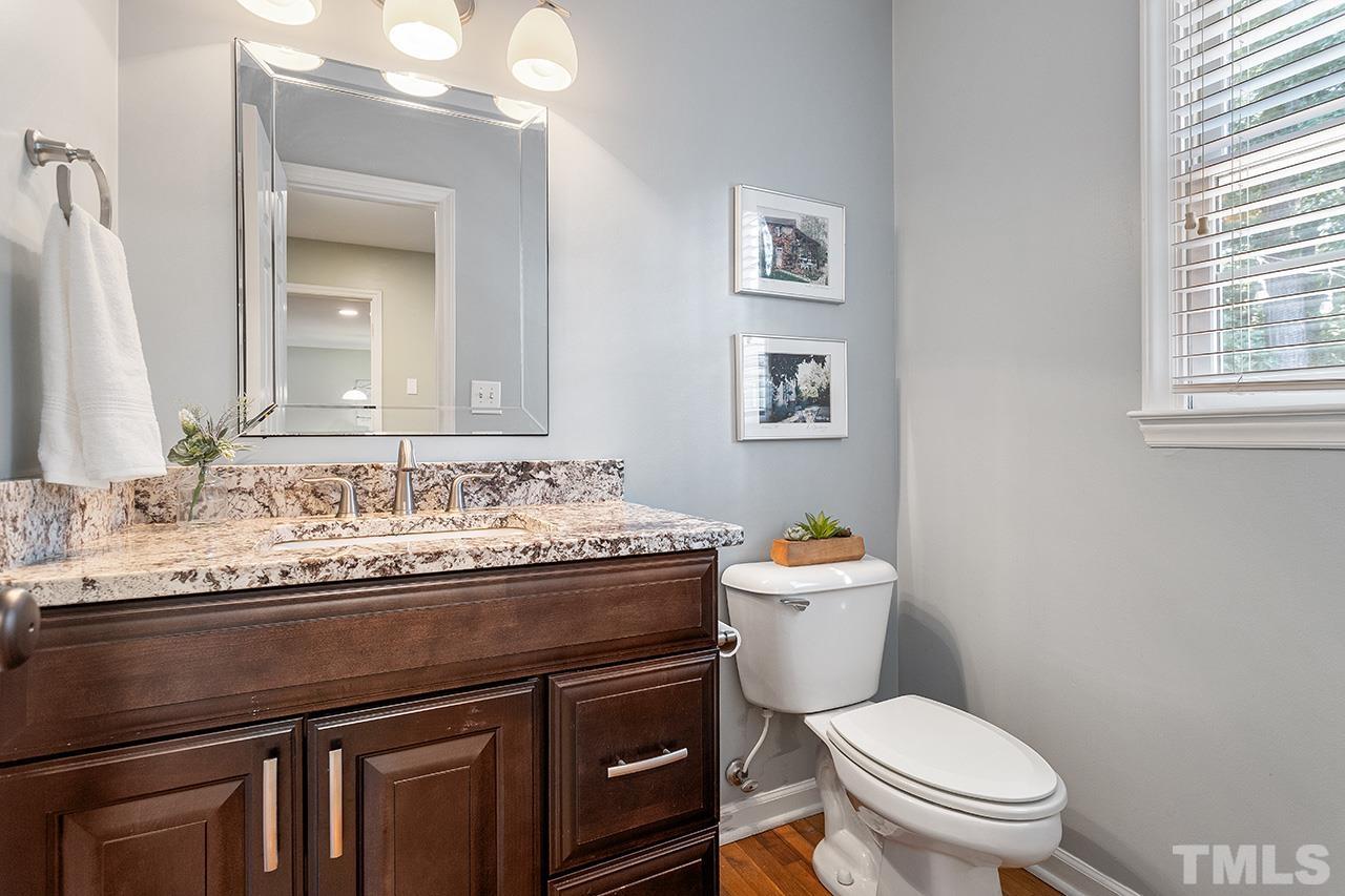 6103 Chesden Drive Durham, NC 27713 - Photo 9 of 22 a bathroom with a granite countertop toilet sink and mirror