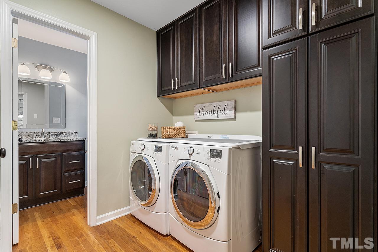 6103 Chesden Drive Durham, NC 27713 - Photo 10 of 22 a view of a kitchen with washer and dryer