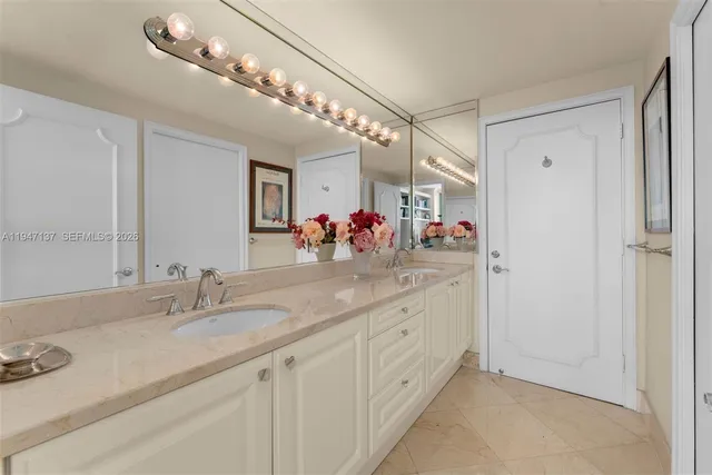 a bathroom with a sink double vanity and a mirror