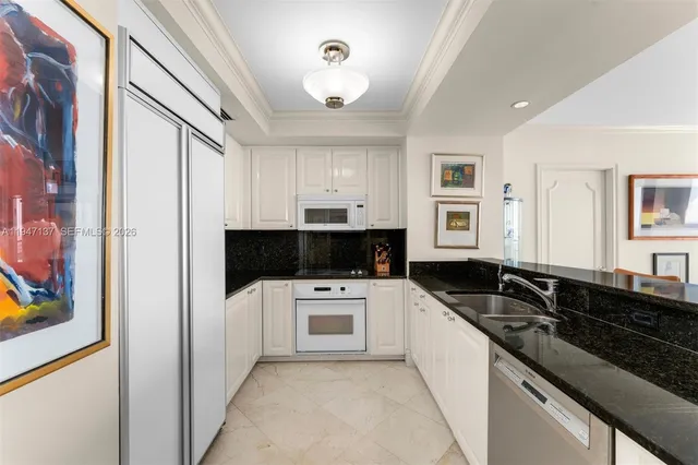 a kitchen that has a sink and a stove in it
