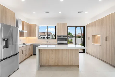 a kitchen with a sink stove and refrigerator
