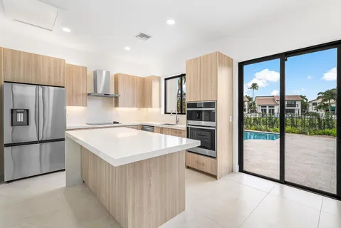 a kitchen with stainless steel appliances a sink cabinets and a refrigerator